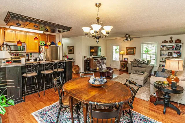 a view of a dining room with furniture and a chandelier