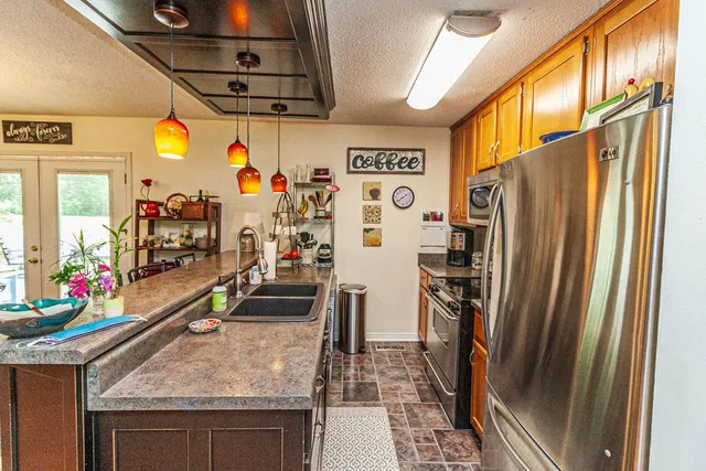 a view of a living room with furniture and a kitchen