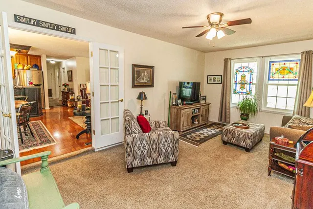 a living room with furniture gym equipment and a table