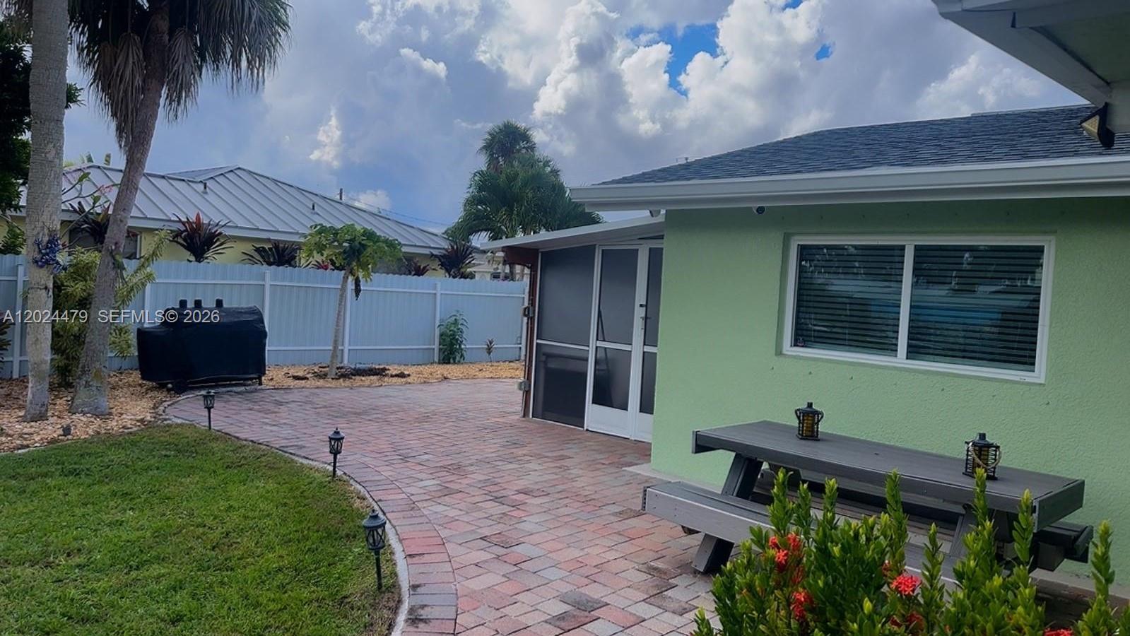 2212 Club House Road North Fort Myers, FL 33917 - Photo 32 of 40 a backyard of a house with table and chairs