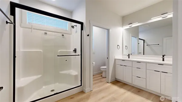 a bathroom with a toilet a sink and mirror