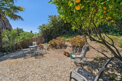 a view of a backyard with sitting area
