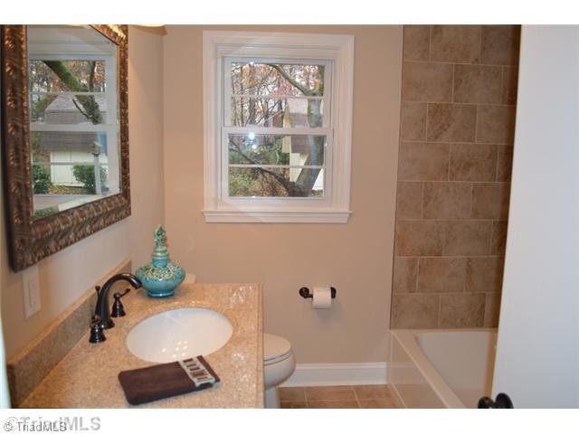 3389 Nottingham Road Winston-Salem, NC 27104 - Photo 12 of 24 Bath. Main level guest bath. Tile surround shower. New vanity with cultured marble countertops and tile flooring