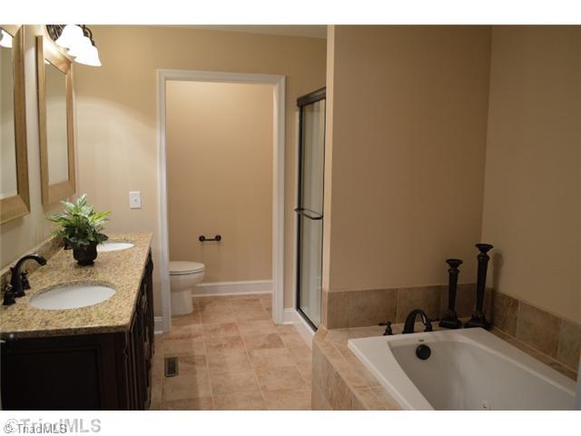 3389 Nottingham Road Winston-Salem, NC 27104 - Photo 16 of 24 Master Bath/Spa. Large master bath boasts dual vanities with granite countertops, jetted garden tub with tile surround and separate walk in shower