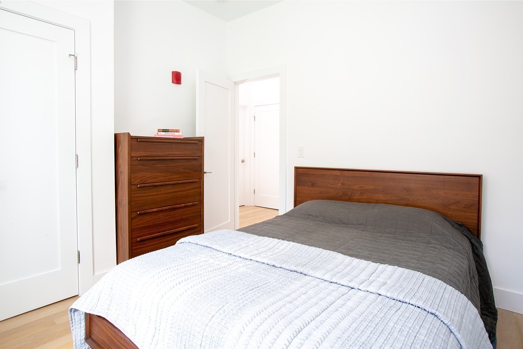 55 East Springfield Street, Unit 4 Boston, MA 02118 - Photo 5 of 7 a bedroom with a bed and dresser