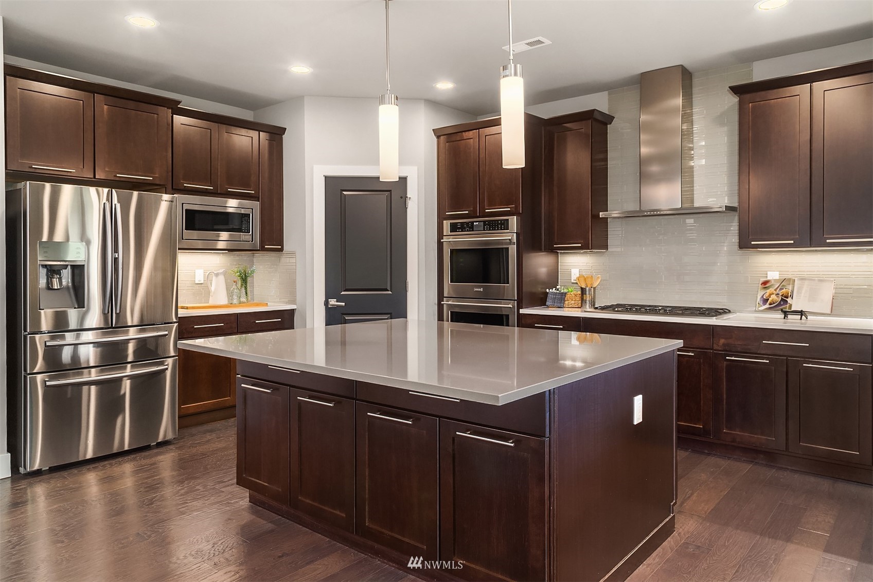 20611 37th Avenue Southeast Bothell, WA 98021 - Photo 13 of 40 a kitchen with stainless steel appliances kitchen island granite countertop a refrigerator and a sink