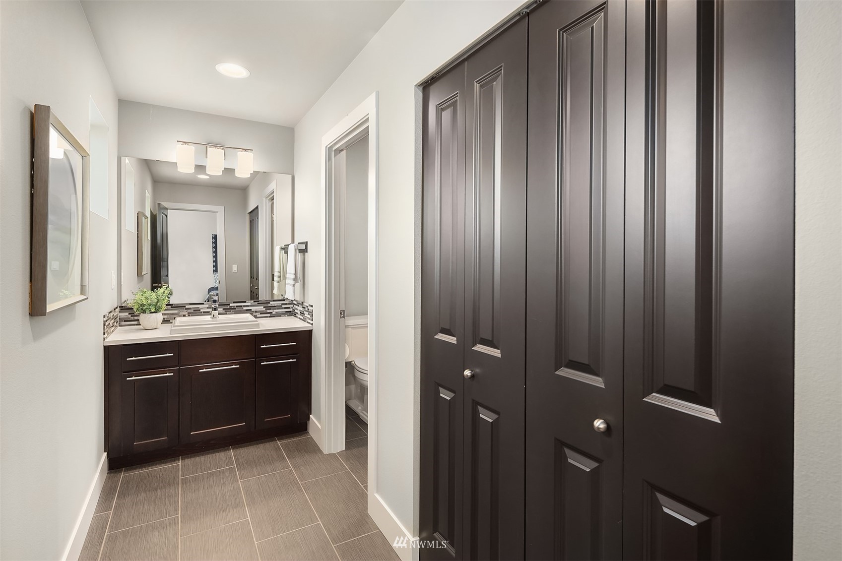 20611 37th Avenue Southeast Bothell, WA 98021 - Photo 24 of 40 a spacious bathroom with a granite countertop sink a mirror and a bathtub