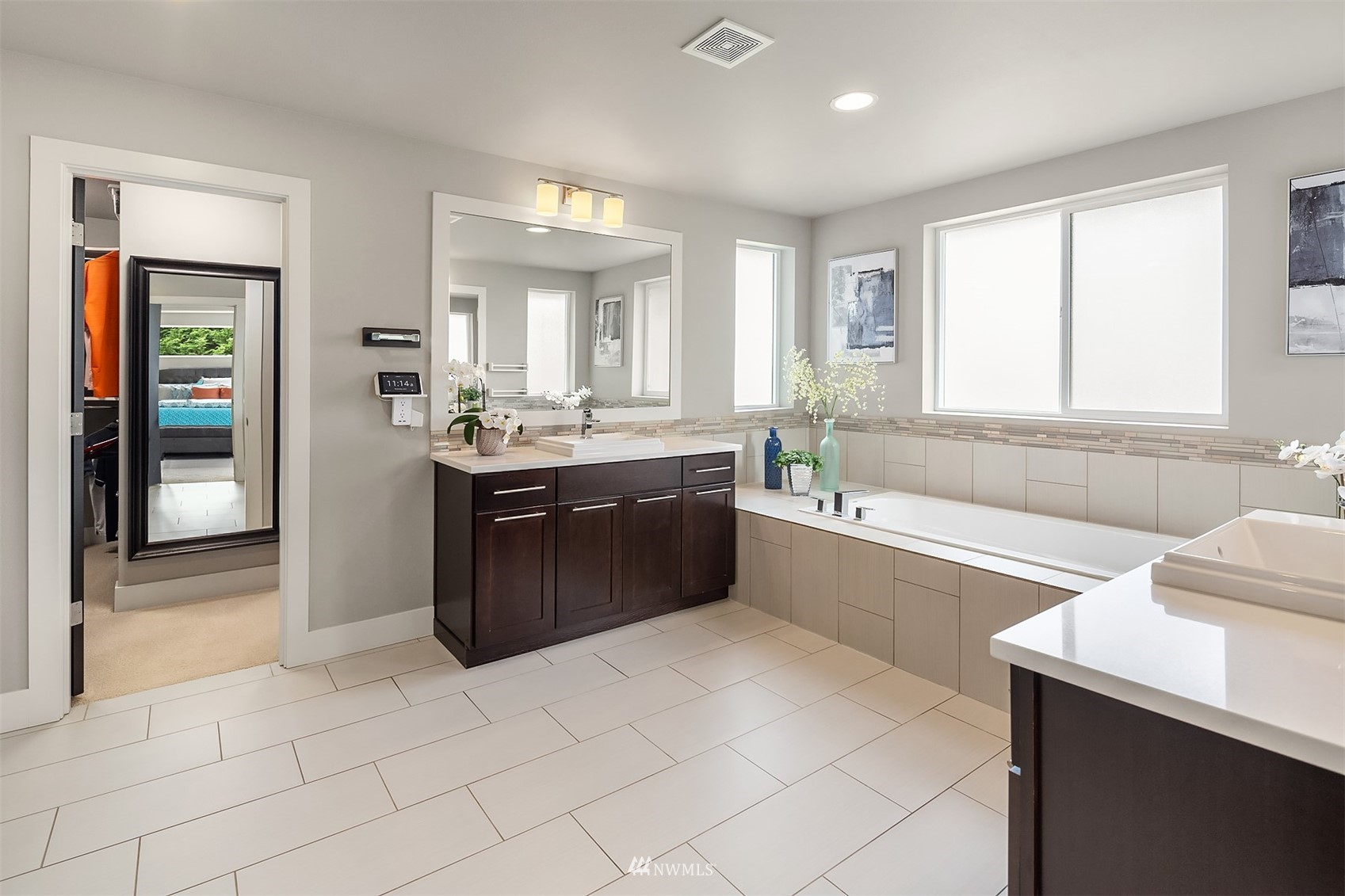 20611 37th Avenue Southeast Bothell, WA 98021 - Photo 31 of 40 a large bathroom with a double vanity sink a large mirror and a bathtub