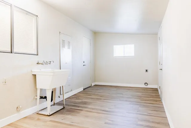 a view of a room with wooden floor and white walls