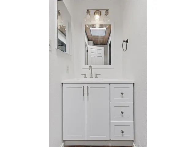 a bathroom with a sink and mirror