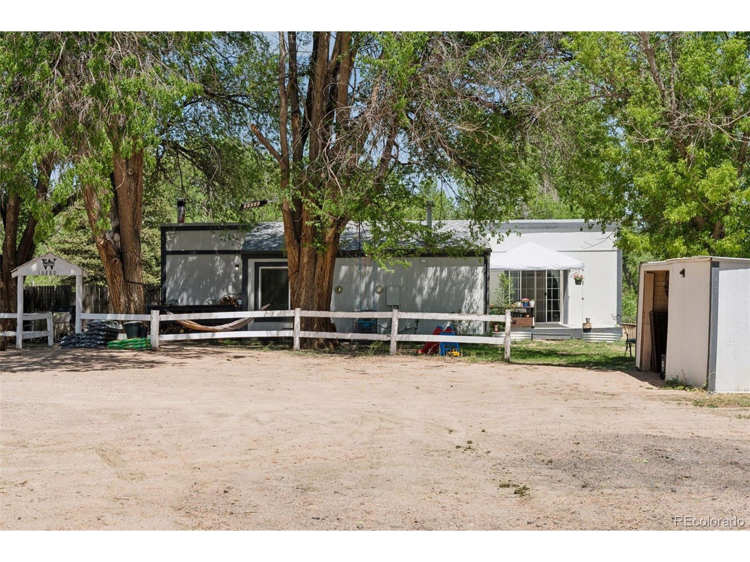 16880 Old Pueblo Road Fountain, CO 80817 - Photo 22 of 49 a view of a house with backyard and a tree