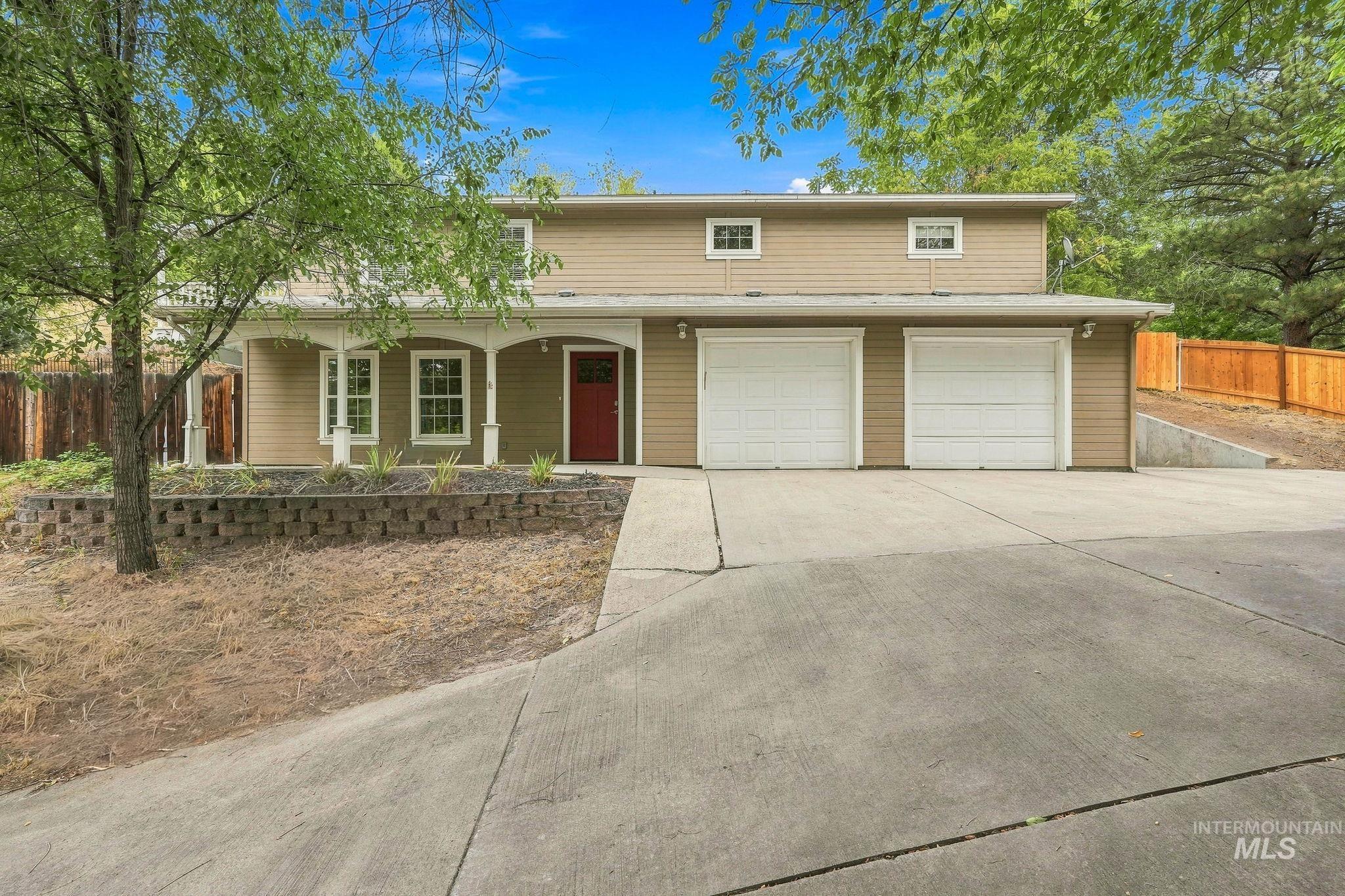 2442 West Hill Road Boise, ID 83702 - Photo 1 of 48 Two-story exterior with a covered porch featuring white columns and a red entry door