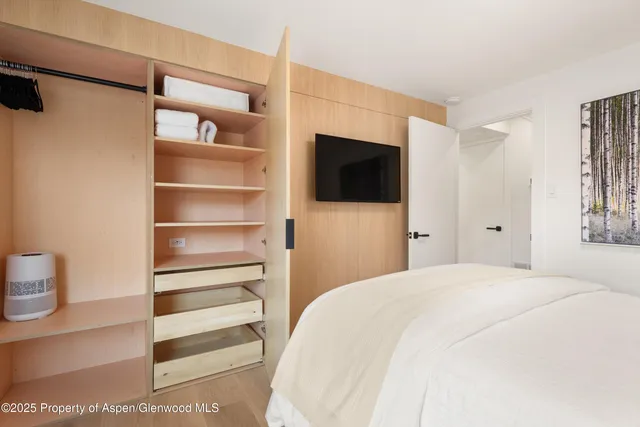 a large white bed in a white room