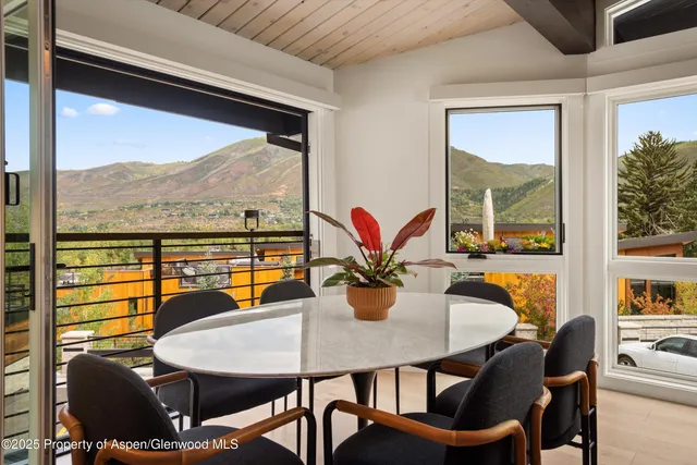 a view of a dining room with furniture window and outside view