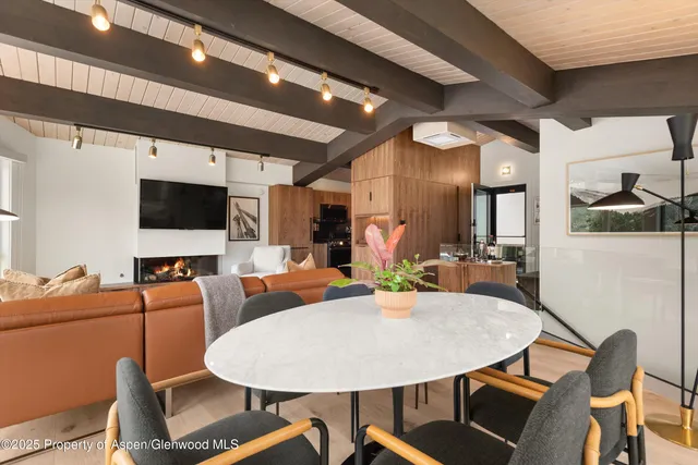 a dining room with furniture and wooden floor