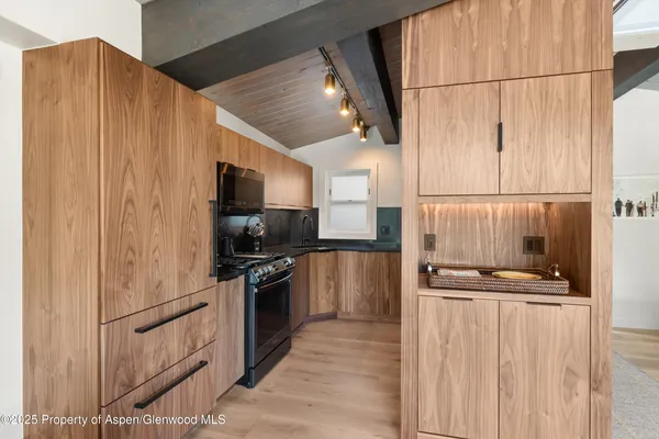 a kitchen with stainless steel appliances a refrigerator and a stove top oven