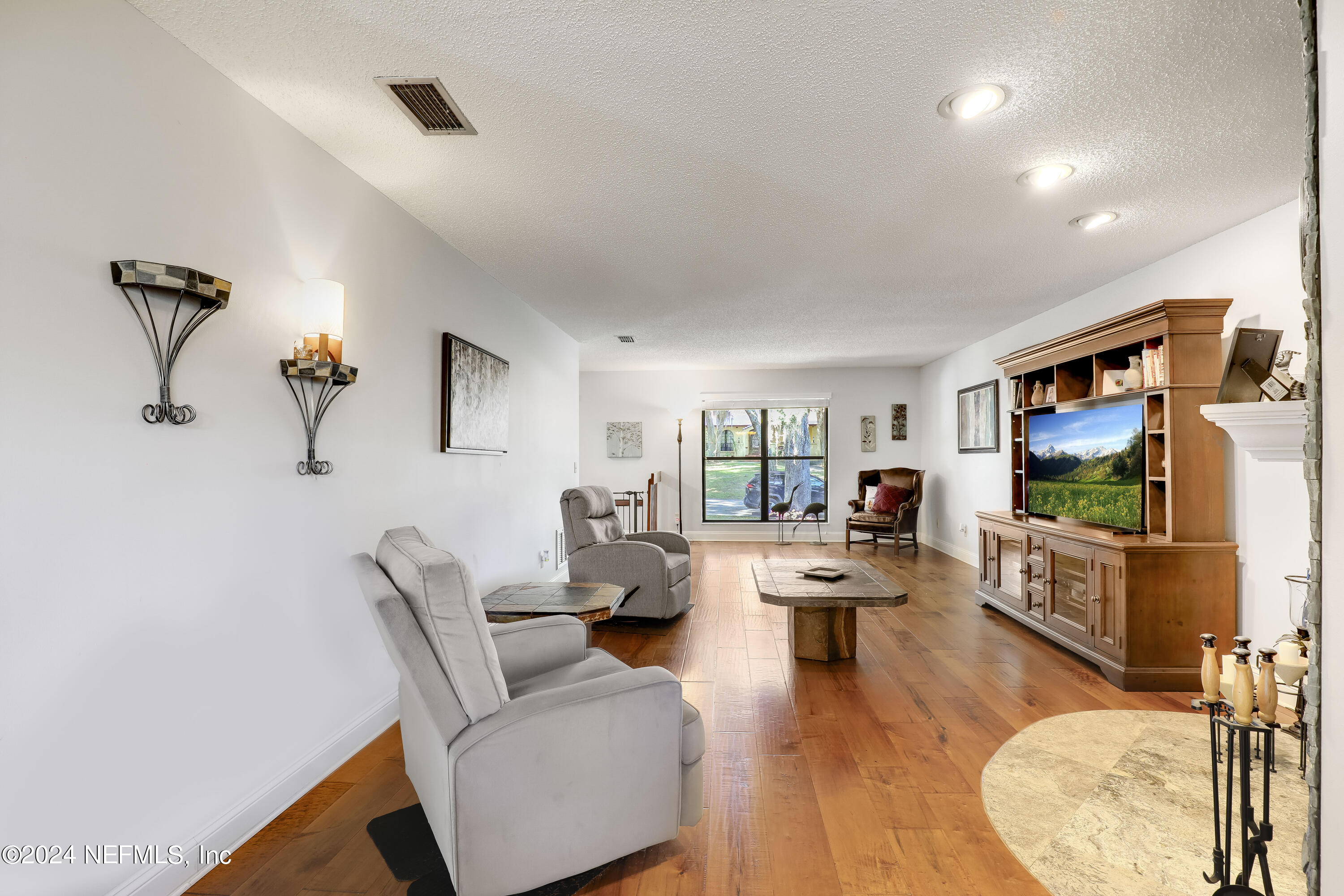 4609 Monument Point Circle Jacksonville, FL 32225 - Photo 14 of 79 a living room with furniture and a flat screen tv