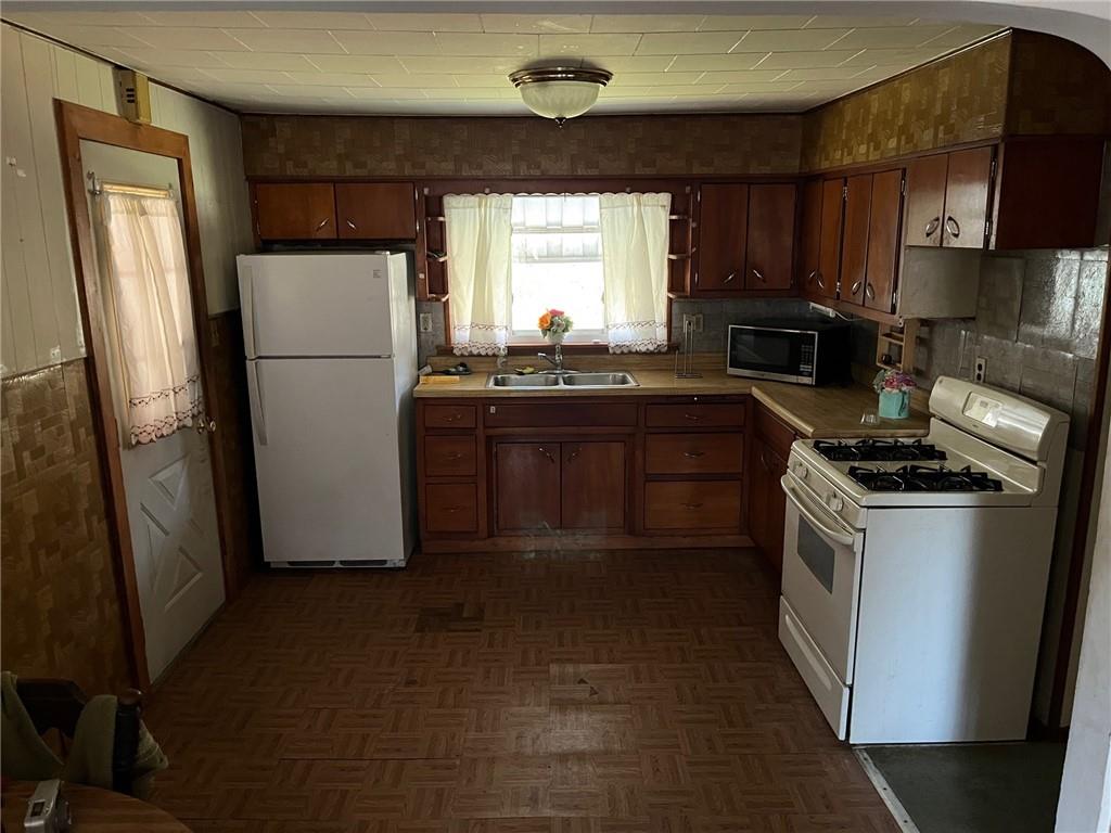 222 Whitten Hollow Road Apollo, PA 15613 - Photo 8 of 10 a kitchen with a refrigerator a sink a stove a microwave and cabinets