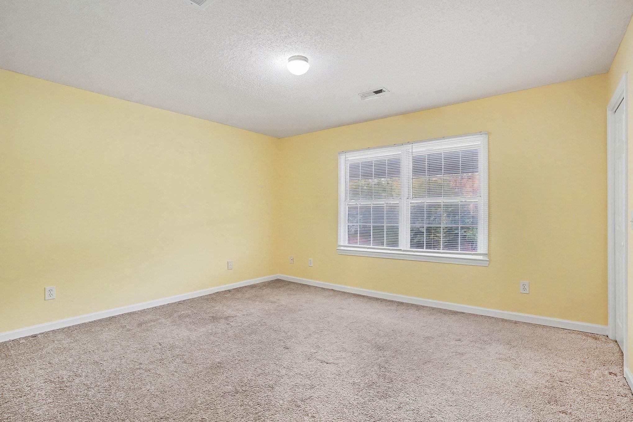 513 65th Avenue North, Unit I Myrtle Beach, SC 29572 - Photo 14 of 21 Master Bedroom featuring a textured ceiling and light carpet