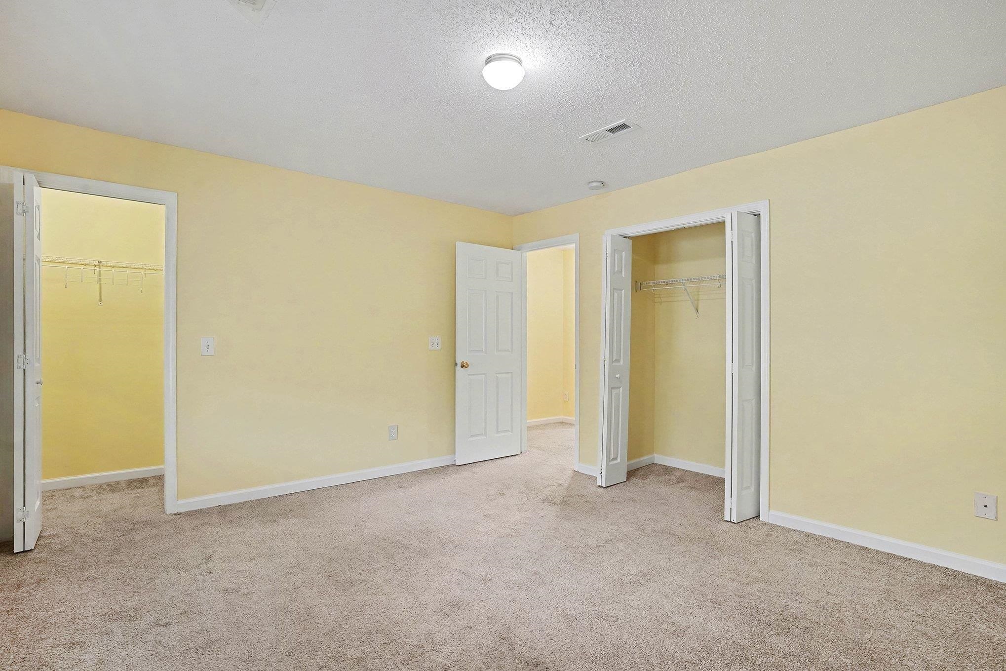 513 65th Avenue North, Unit I Myrtle Beach, SC 29572 - Photo 15 of 21 Master Bedroom featuring light carpet and a textured ceiling