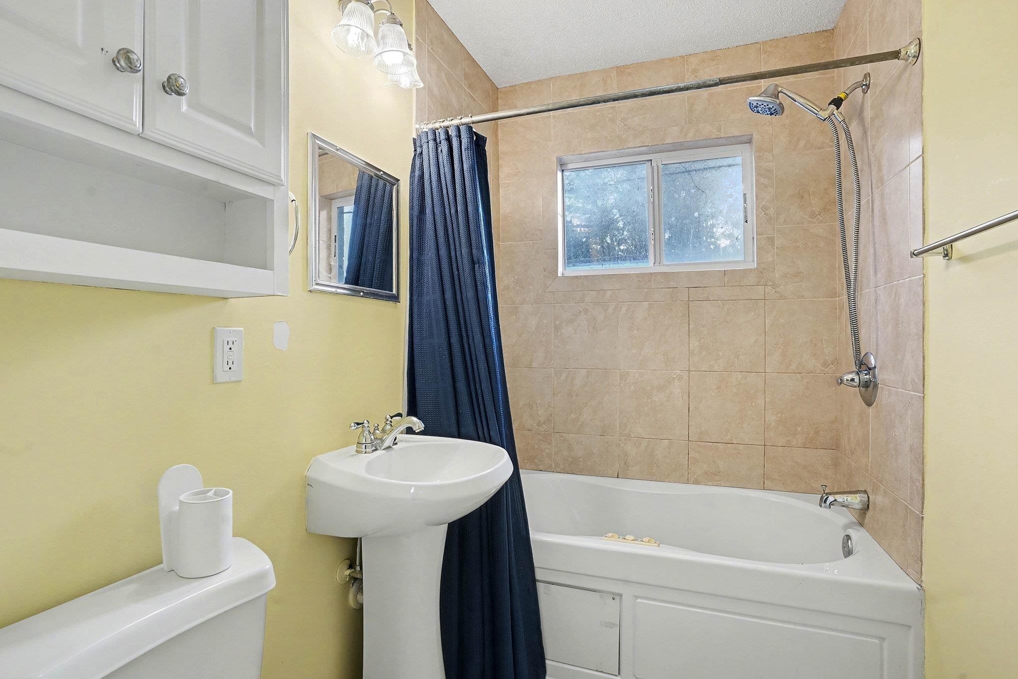 513 65th Avenue North, Unit I Myrtle Beach, SC 29572 - Photo 16 of 21 Full upstairs bathroom featuring shower / tub combo with curtain and toilet
