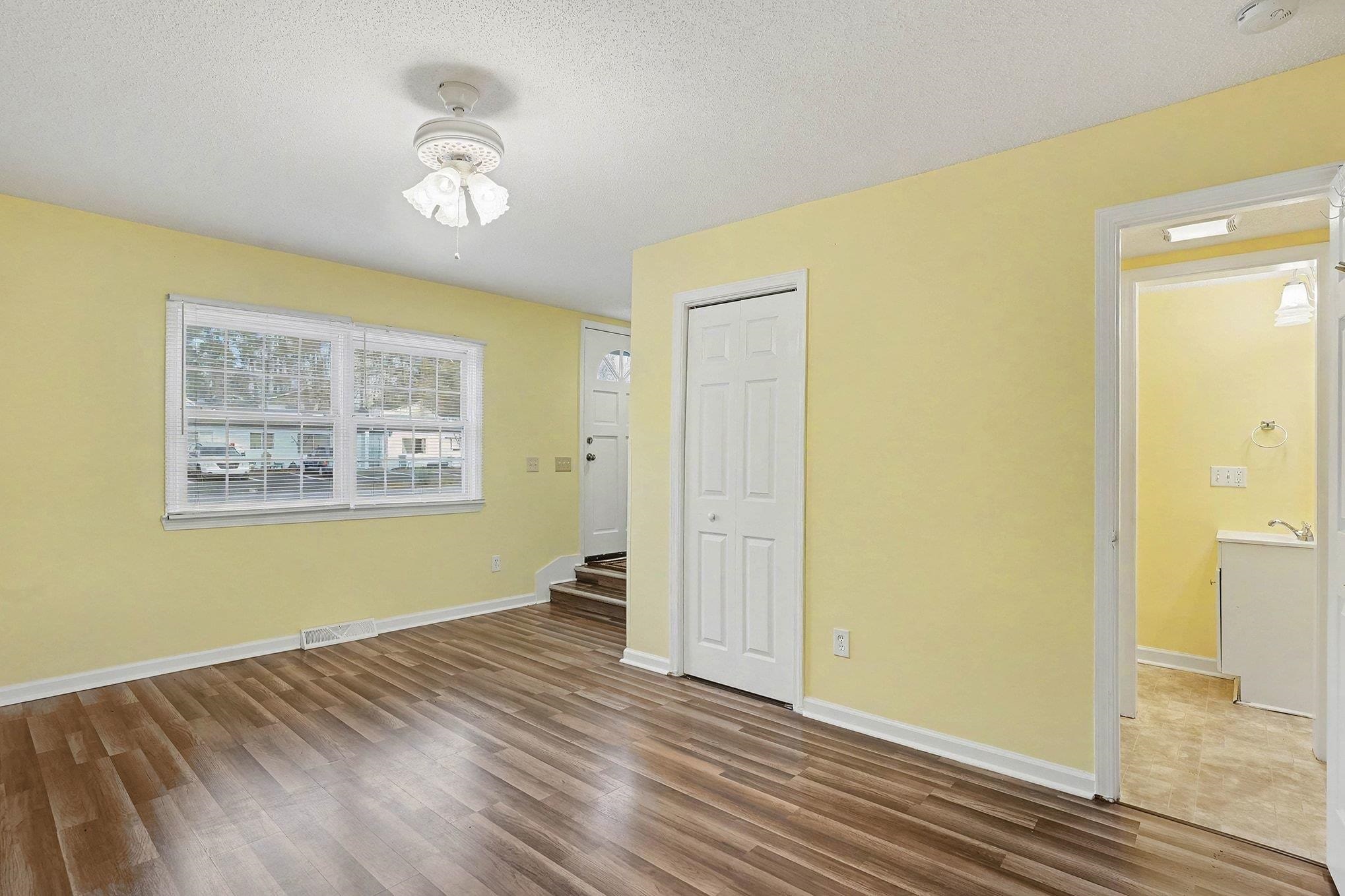513 65th Avenue North, Unit I Myrtle Beach, SC 29572 - Photo 5 of 21 Unfurnished living room with LVP floors, a textured ceiling, a ceiling fan, and a full bathroom