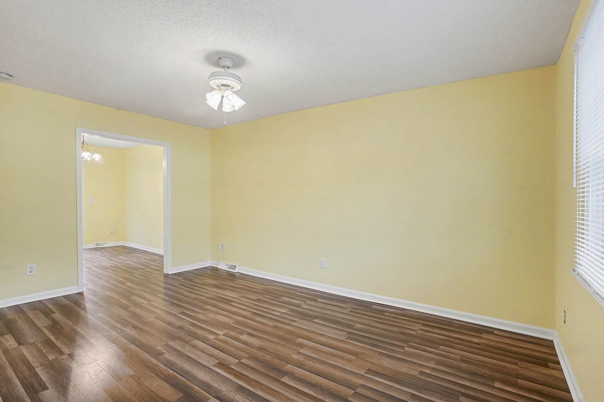 513 65th Avenue North, Unit I Myrtle Beach, SC 29572 - Photo 6 of 21 Unfurnished room featuring dark LVP floors and a textured ceiling.