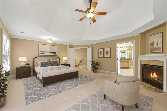 a spacious bedroom with a large bed a fireplace and a chandelier