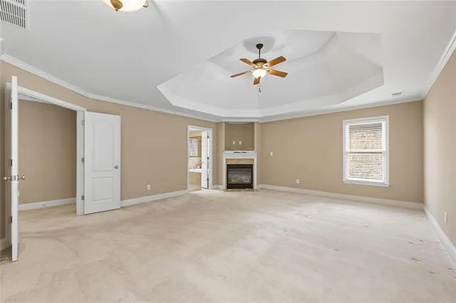 a view of an empty room with a fireplace and a window