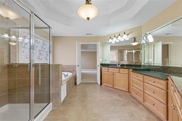 a large bathroom with a double vanity sink a mirror and a shower