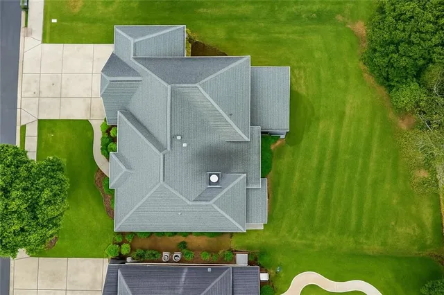 an aerial view of a house with a yard