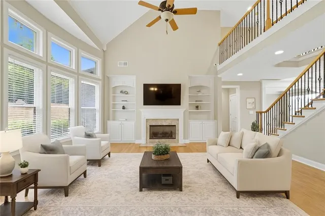 a living room with furniture fireplace and flat screen tv
