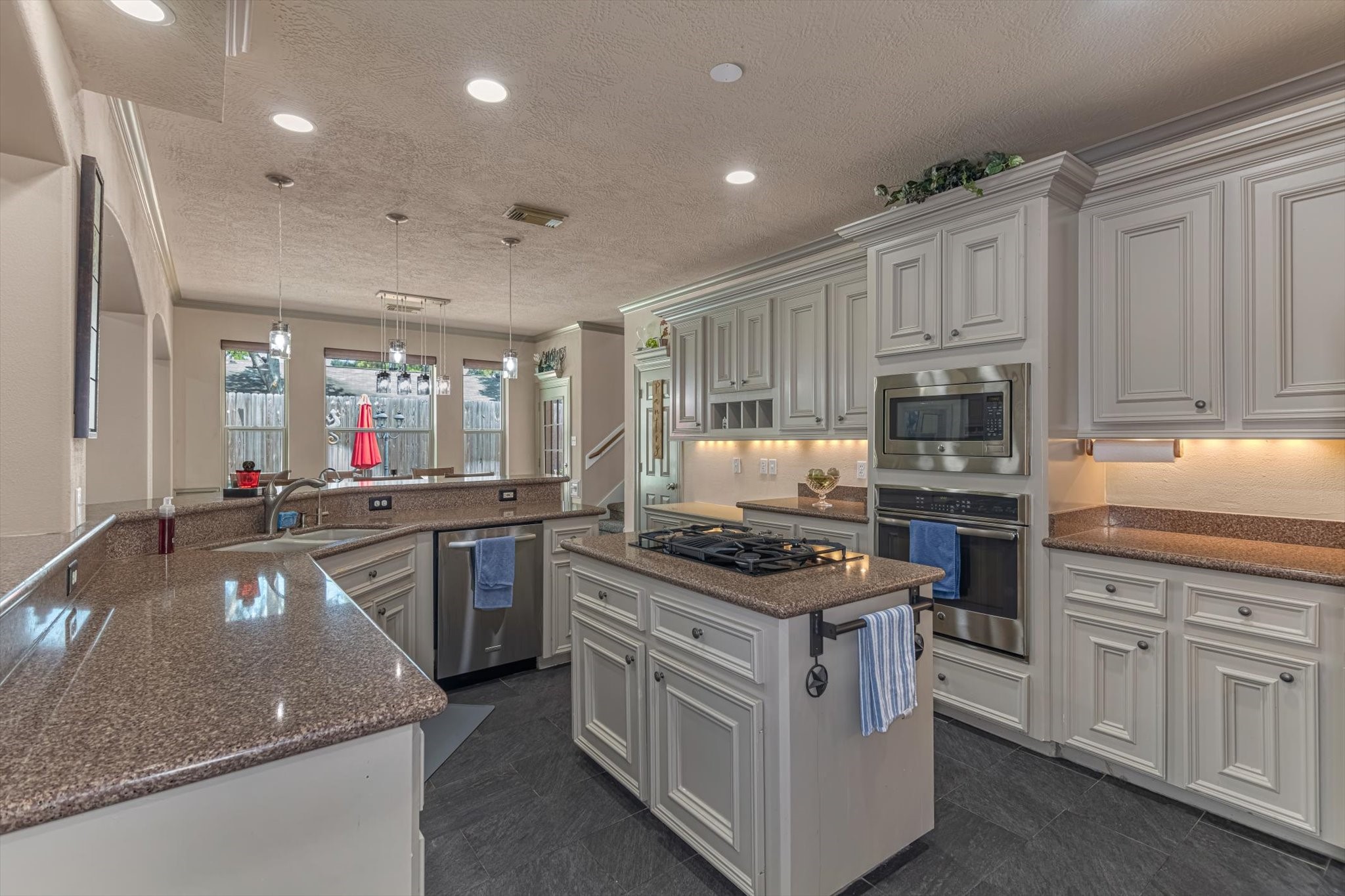 18422 Bivens Bend Spring, TX 77379 - Photo 13 of 50 a kitchen with stainless steel appliances granite countertop a stove a sink and a refrigerator