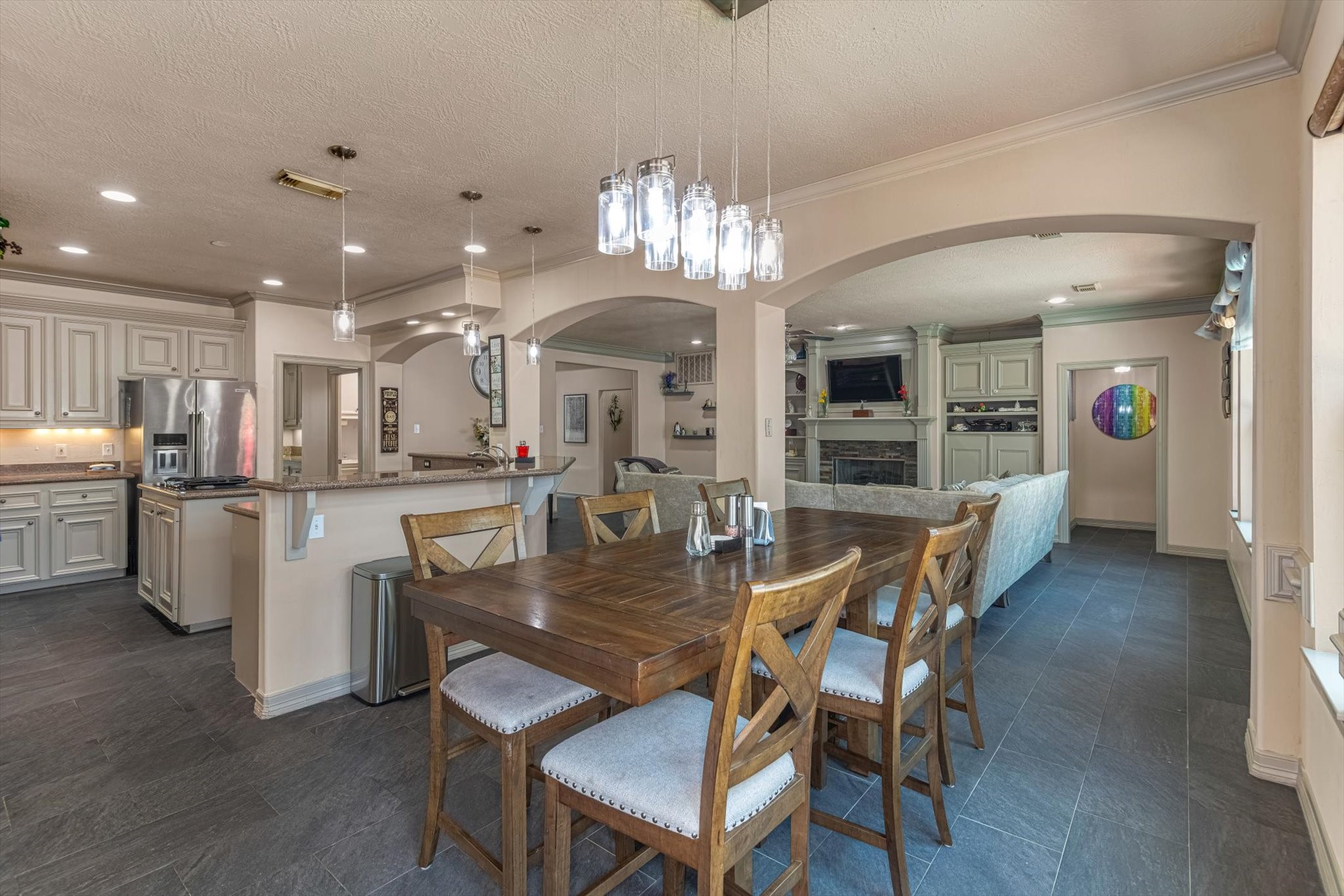 18422 Bivens Bend Spring, TX 77379 - Photo 17 of 50 a dining room with kitchen island stainless steel appliances furniture a chandelier and kitchen view