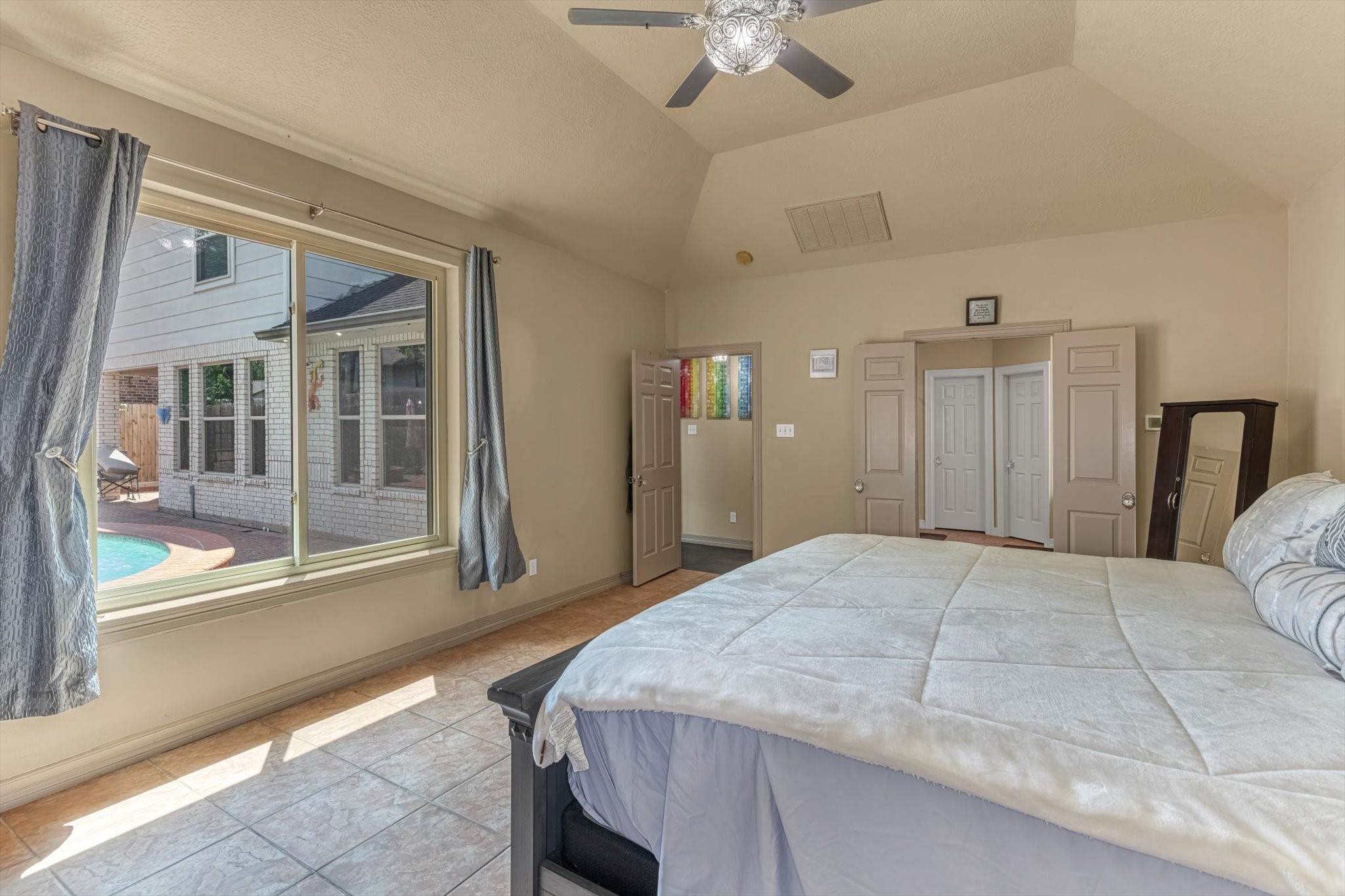 18422 Bivens Bend Spring, TX 77379 - Photo 22 of 50 a bedroom with a large bed and a large window