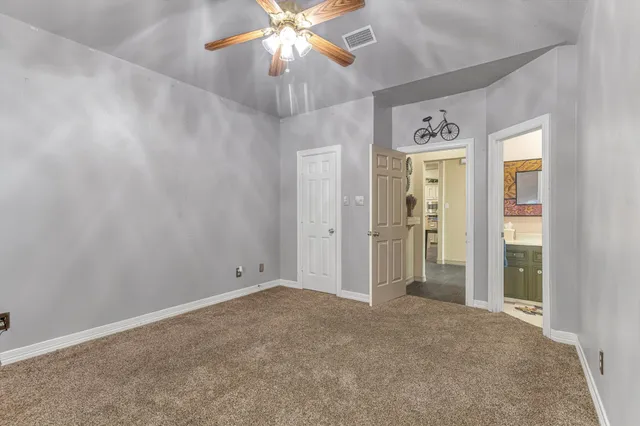 a bathroom with a granite countertop sink a toilet and a shower curtain