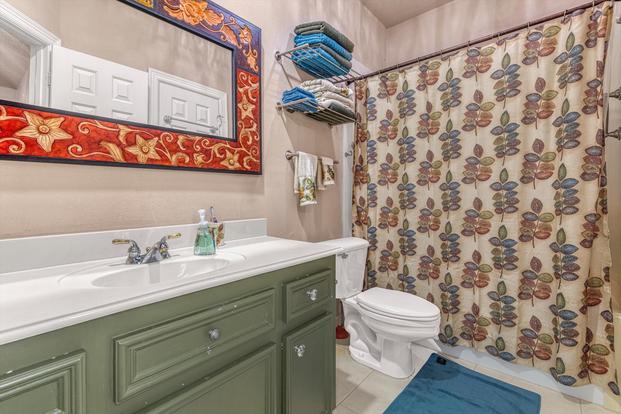 18422 Bivens Bend Spring, TX 77379 - Photo 30 of 50 a bathroom with a granite countertop sink a toilet and a shower curtain