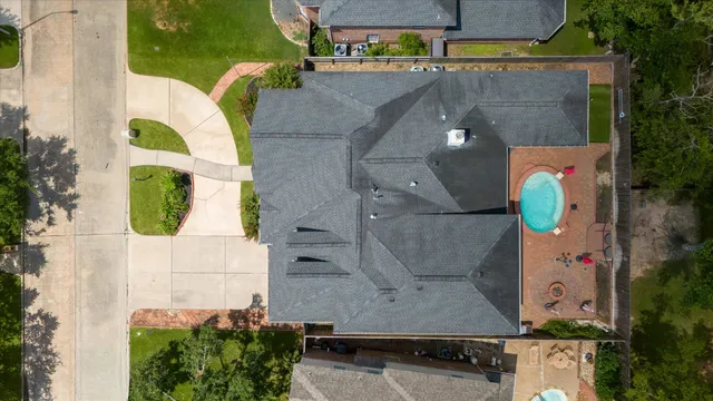 an aerial view of a house with a swimming pool