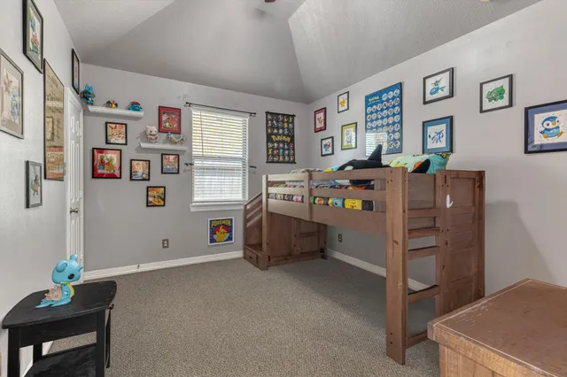a bedroom with furniture and a window
