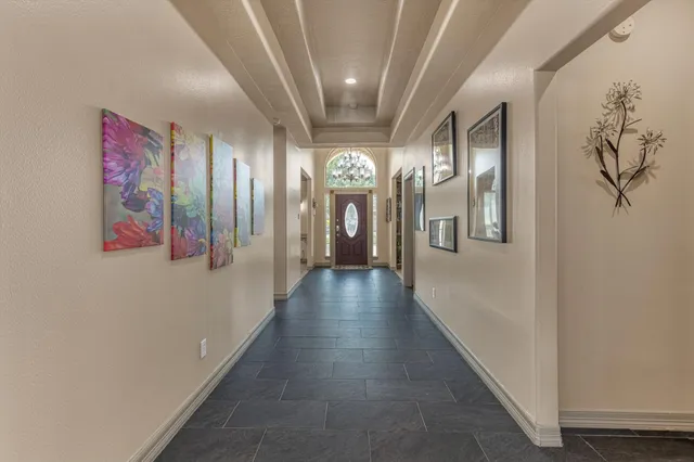 a view of a hallway with entryway front door