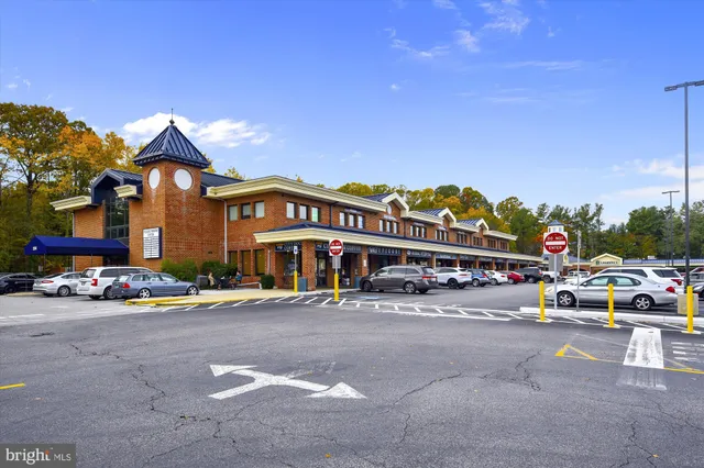 a view of a cars park in front of a building