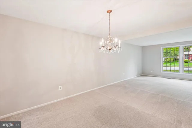 a view of a room with windows and ceiling fan