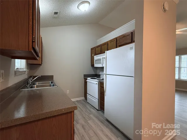 a kitchen with a refrigerator and a sink