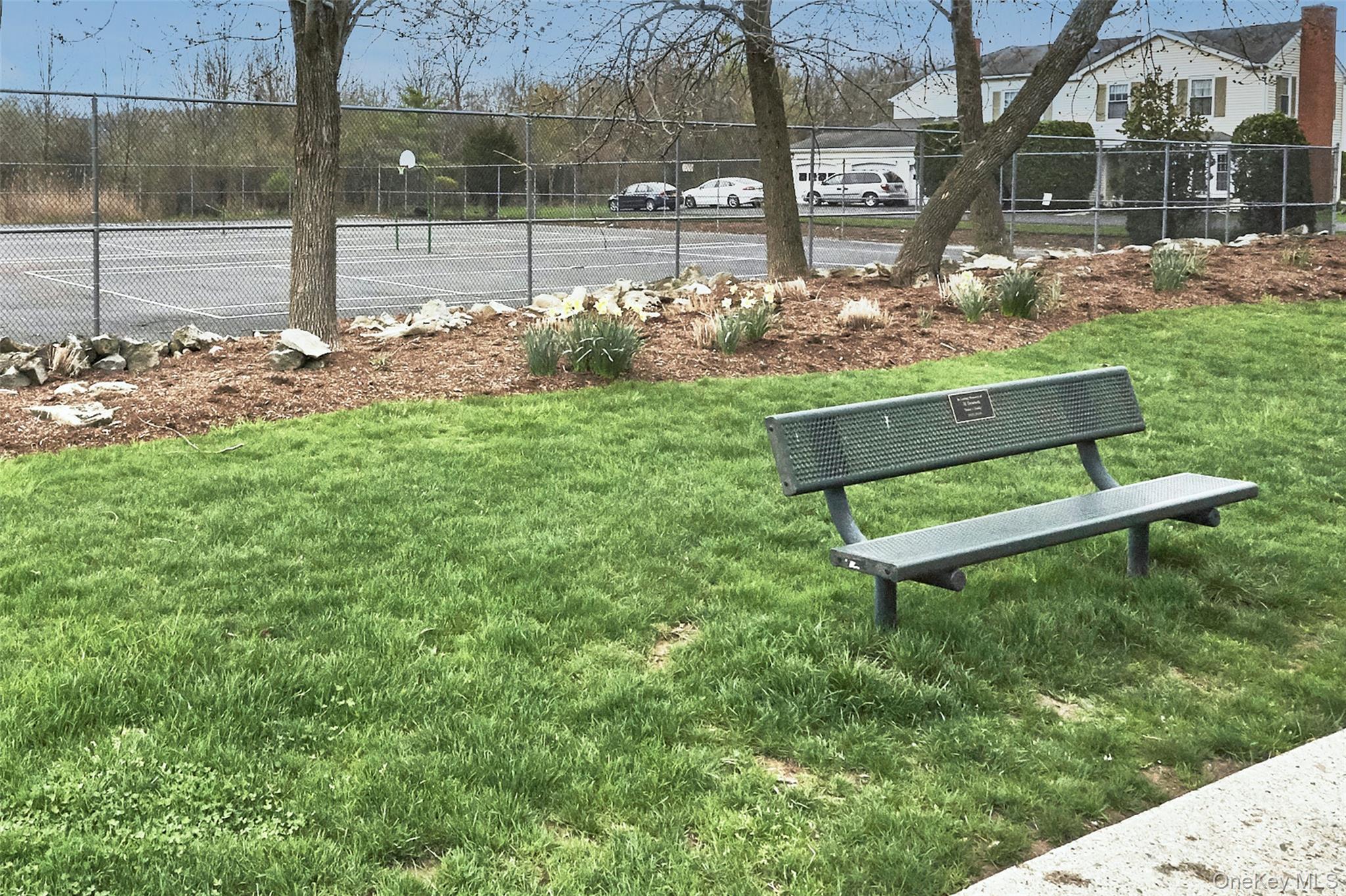 46 The Rise Warwick, NY 10990 - Photo 18 of 22 a white bench sitting in the middle of a park