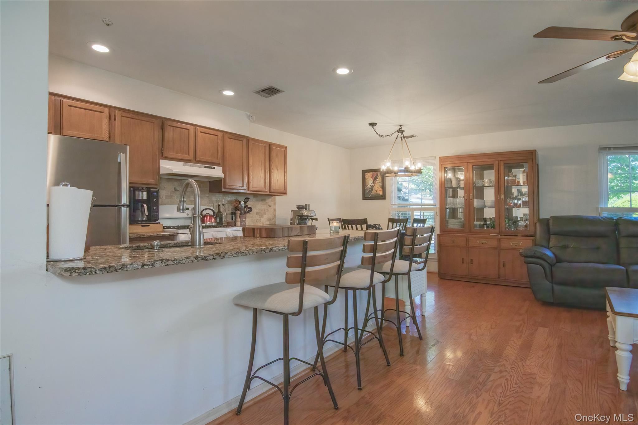 46 The Rise Warwick, NY 10990 - Photo 6 of 22 a kitchen with stainless steel appliances granite countertop a table chairs stove a refrigerator and cabinets