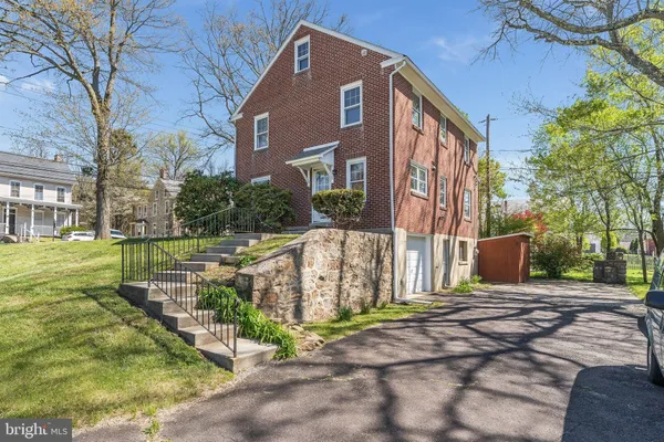 a view of a brick house with a yard