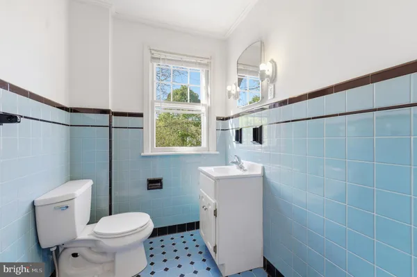 a bathroom with a sink mirror and toilet