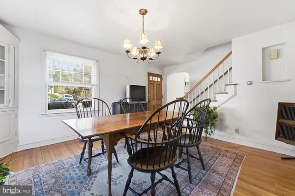 a view of a dining room with furniture wooden floor and chandelier