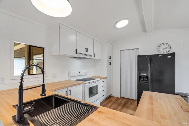 a kitchen with stainless steel appliances granite countertop a refrigerator and a stove top oven