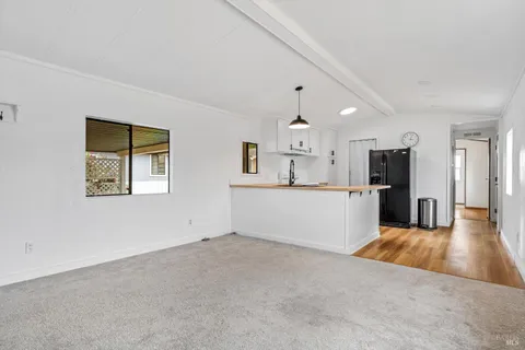 a view of a kitchen with a sink and a window